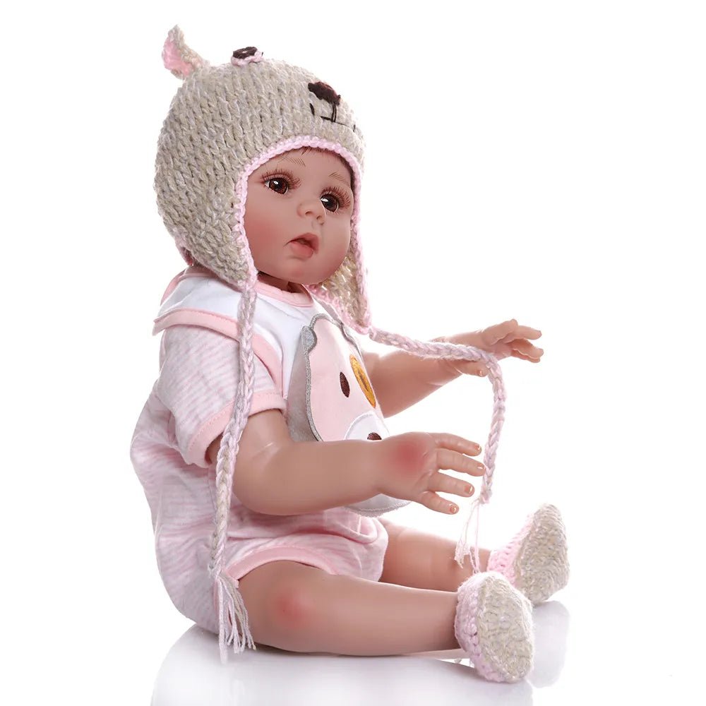 Baby doll wearing a crocheted hat and outfit.