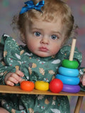 Child with a colorful abacus and toys on a table