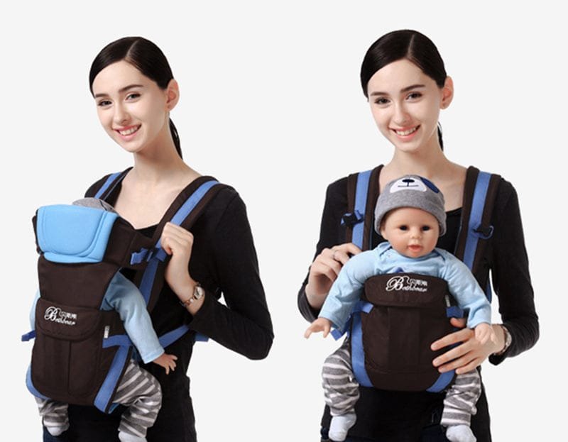 Woman holding a baby in a carrier 