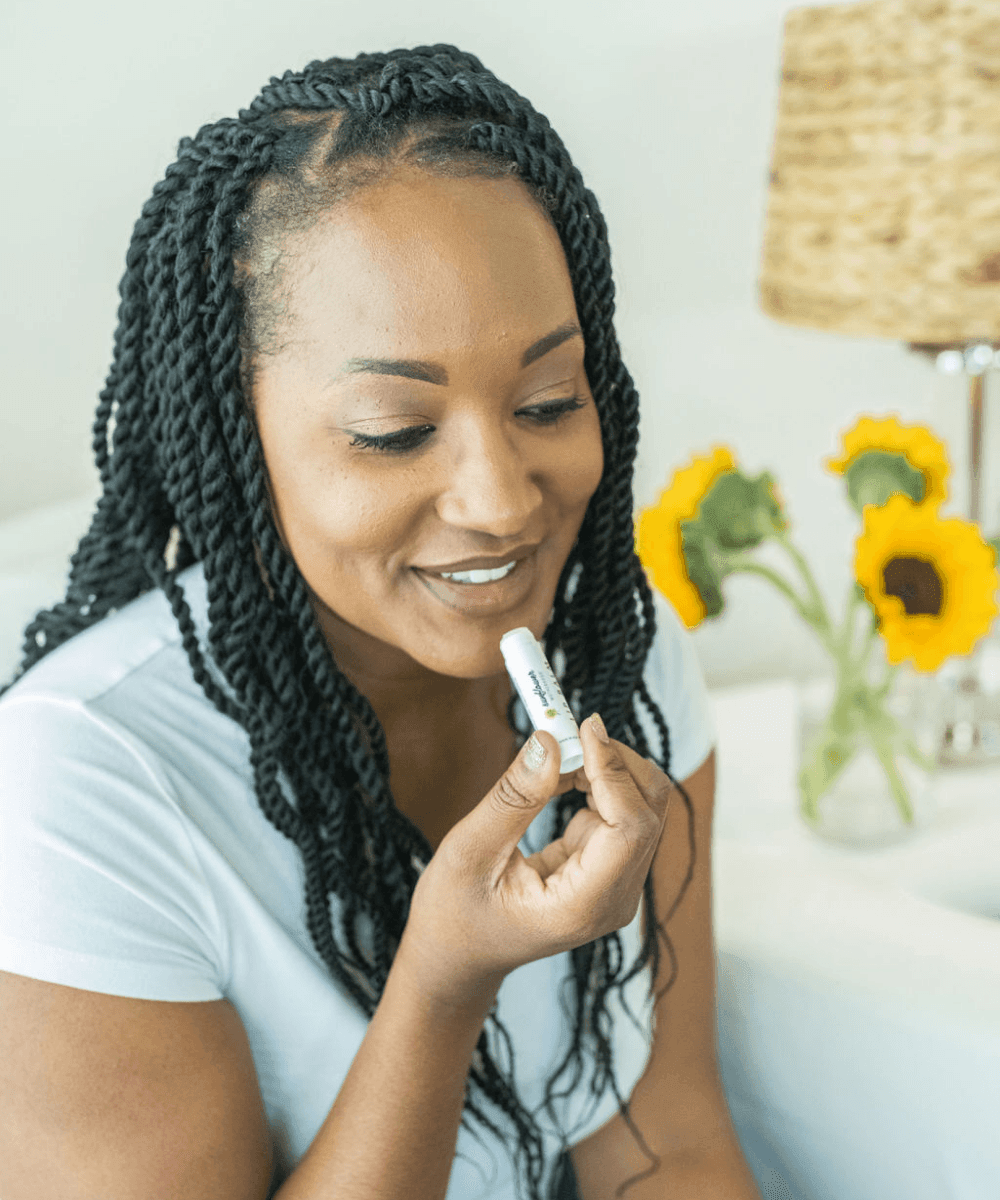 A woman applying lip balm 