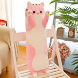 Large pink and beige cat-shaped plush toy on a wooden chair
