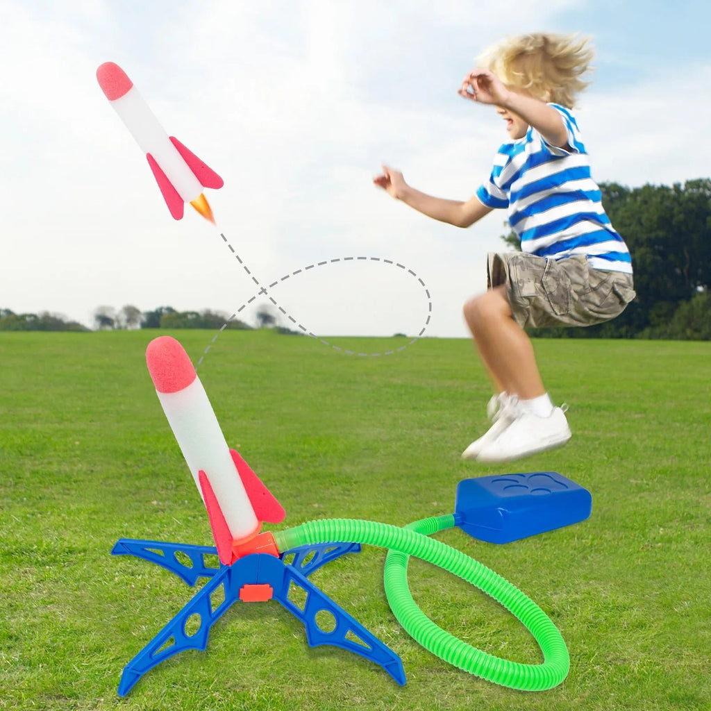 Child playing with a toy water gun and rocket Launcher on grass