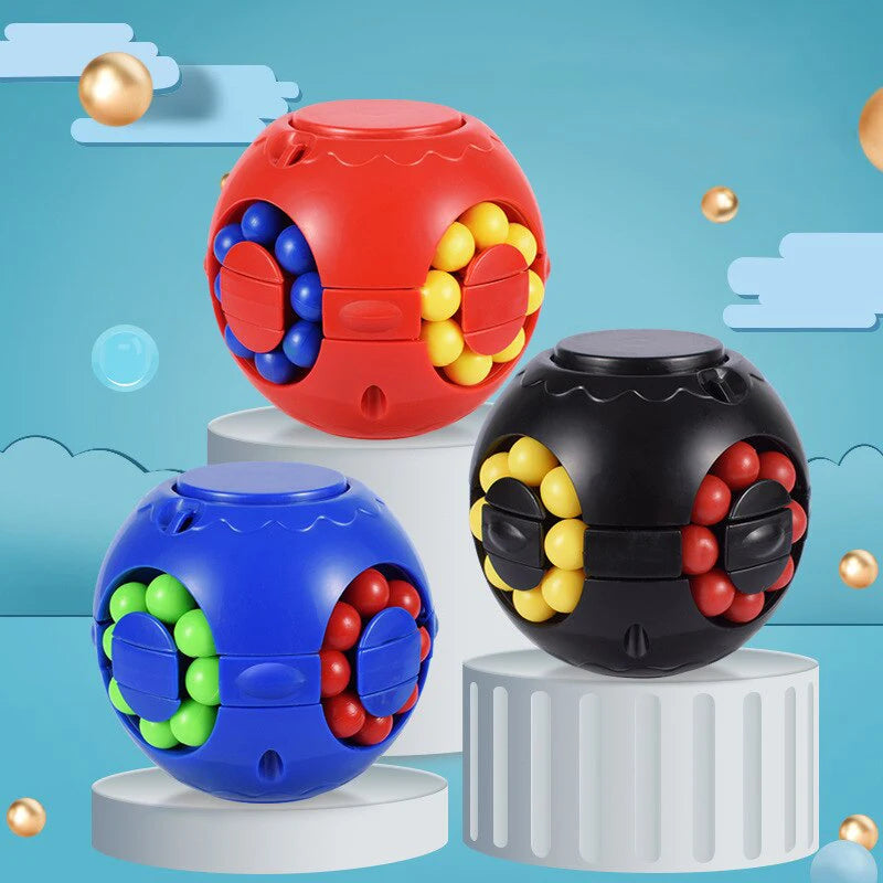 Three colorful puzzle balls on cylindrical platforms.