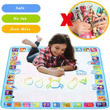Child playing on a colorful learning mat with letters and numbers, surrounded by crayons.