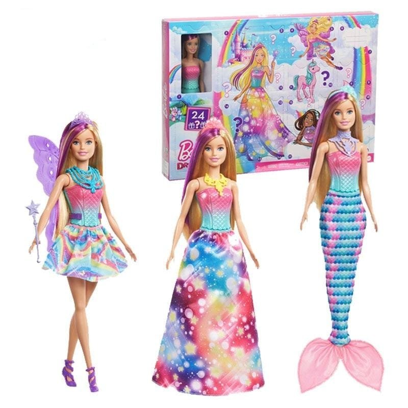 Three colorful dolls with a fairy, mermaid, and princess outfit in front of their packaging.