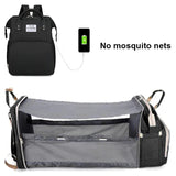 Black backpack with charging cable and gray baby crib