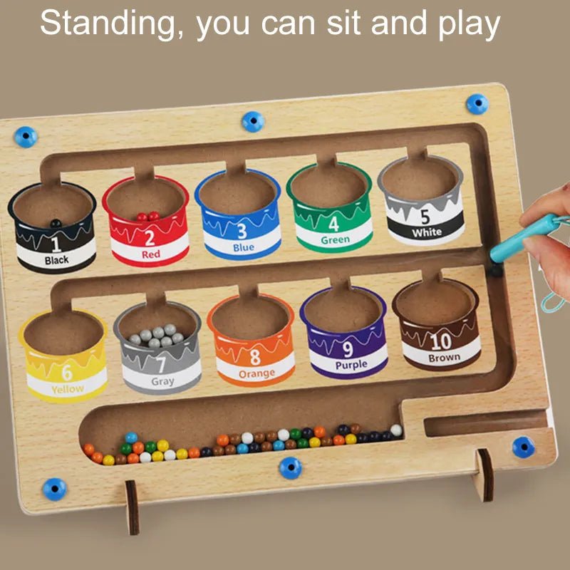 Wooden educational toy with color sorting cups and a hand interacting with it.
