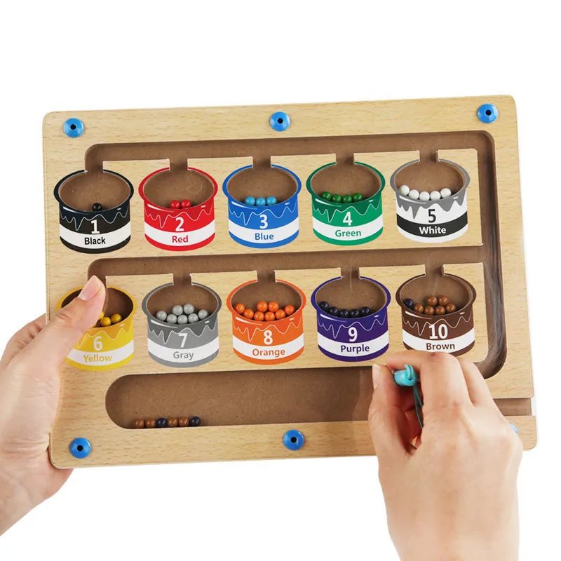 Color sorting toy with wooden frame and labeled containers filled with colored beads.