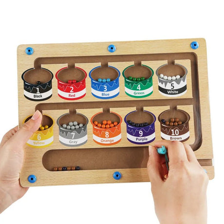 Color sorting toy with wooden frame and labeled containers filled with colored beads.