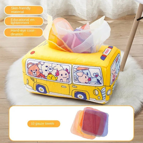 Yellow cartoon bus-shaped tissue box with tissues on a wooden floor.