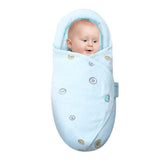 Baby wrapped in a light blue swaddle 
