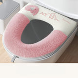 Pink and white toilet seat cover with 'home' text on a toilet.
