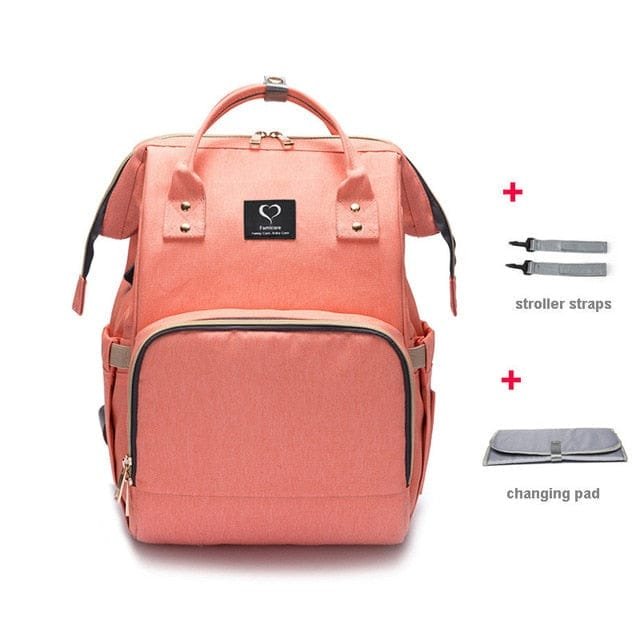Pink backpack with stroller straps and changing pad on a white background