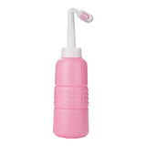 Pink colored cleaning device with white nozzle on a white background
