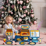 A child with a toy pizza shop set in front of a decorated Christmas tree