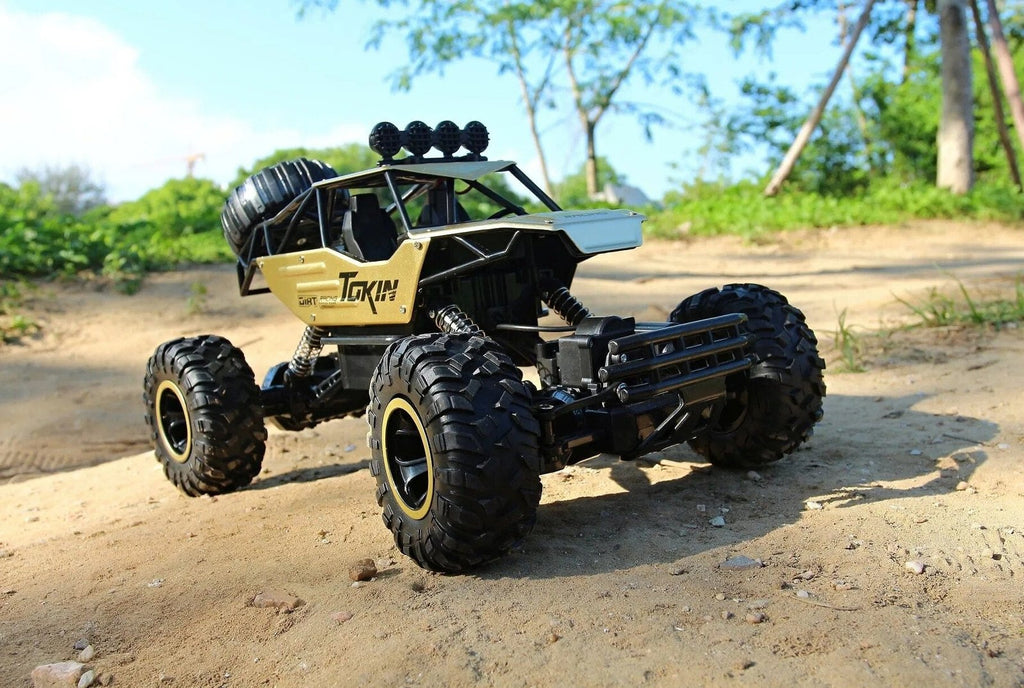 Toy monster truck on a dirt road.
