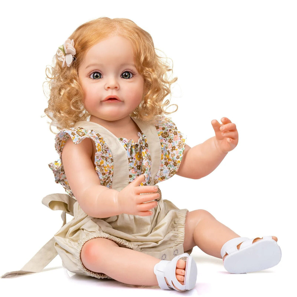Realistic baby doll with blonde hair and a floral dress.
