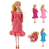 Pregnant doll in a pink dress with a baby doll, on a white background
