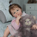 Child with a lion plush toy in a bedroom setting
