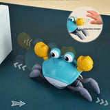 Toy crab with blue body, yellow pincers, and gray legs.