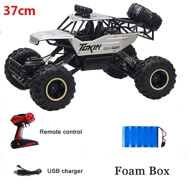 Toy truck with remote control, USB charger, and foam box.