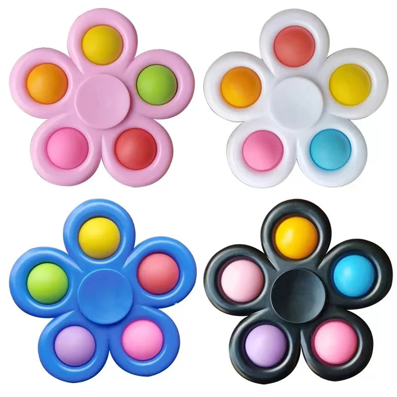 Four flower-shaped fidget toys with colorful centers on a white background