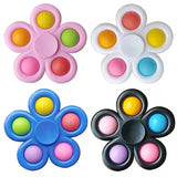 Four flower-shaped fidget toys with colorful centers on a white background