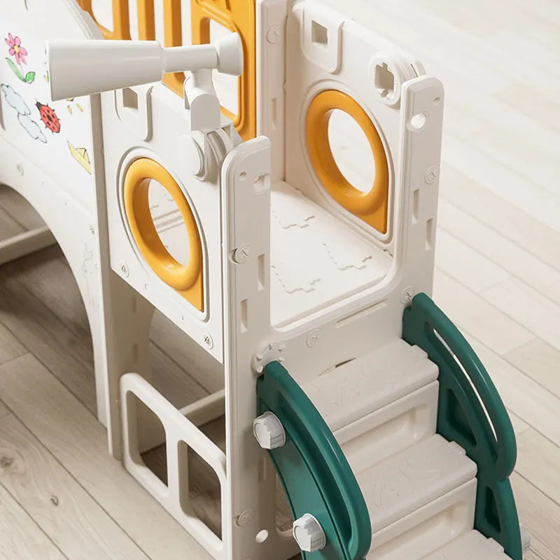 Children's play structure with slide and stairs on a wooden floor