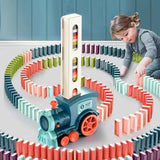 Child playing with a colorful train-themed domino set on a light blue floor.