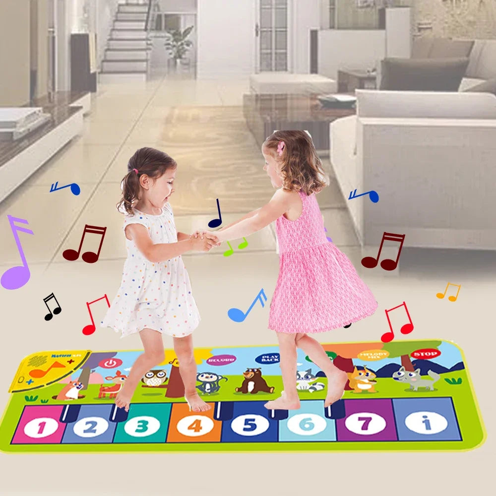 Two children playing on a colorful musical mat in a living room.