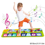 Child playing on a colorful musical mat with music notes around