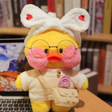 Stuffed toy duck with glasses and a white outfit in front of a bookshelf