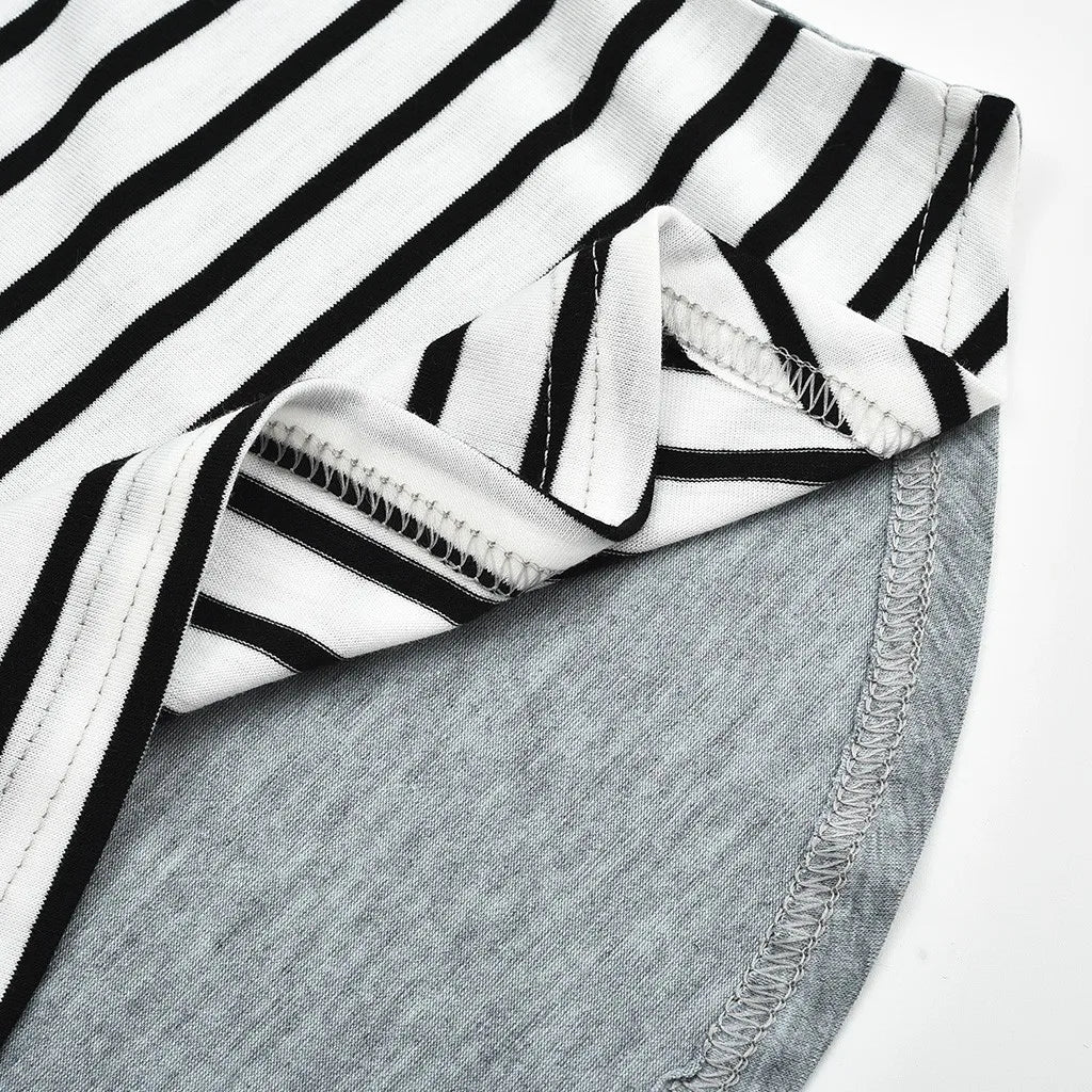 Close-up of a black and white striped fabric with gray denim fabric underneath.