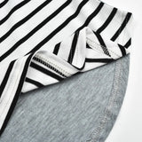 Close-up of a black and white striped fabric with gray denim fabric underneath.