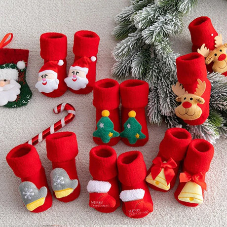 Set of red Christmas-themed dog boots with decorative elements on a light background.