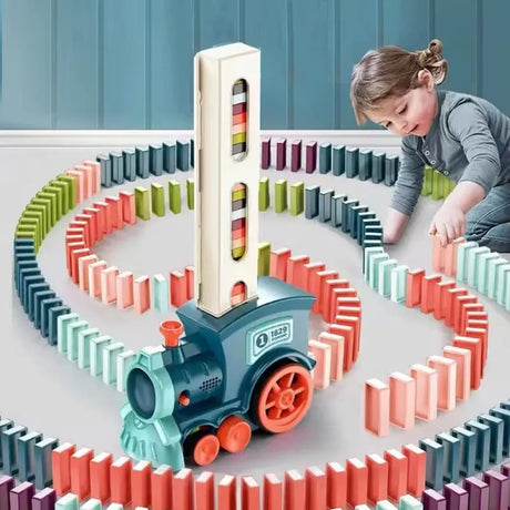 Child playing with a colorful domino train set on a table.