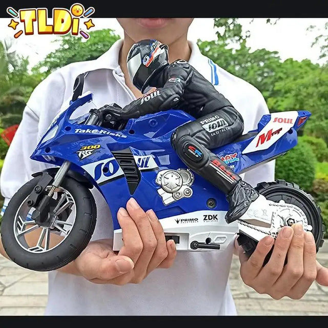 Person holding a blue toy motorcycle with visible branding