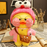 Plush toy duck wearing a pink hat and glasses on a desk