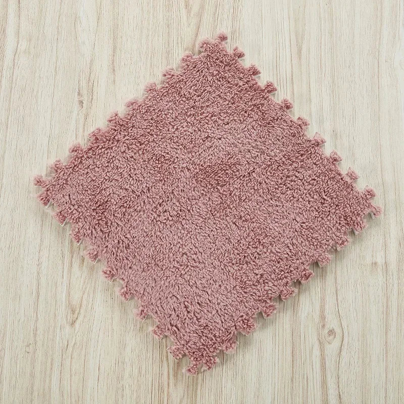 Pink textured rug on a wooden floor