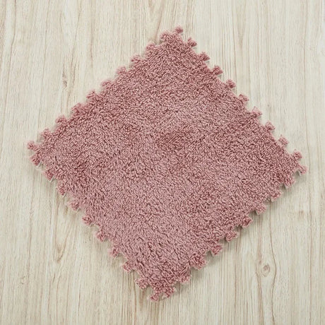 Pink textured rug on a wooden floor