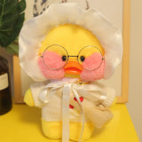 Plush toy duck wearing glasses and a white outfit on a yellow surface