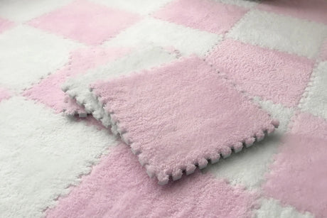 Pink and white checkered blanket with textured surface