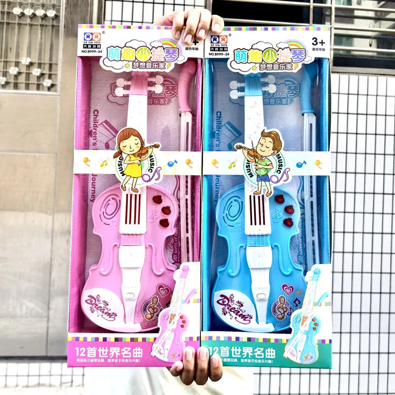Children's musical instrument toys in pink and blue packaging held by a hand.