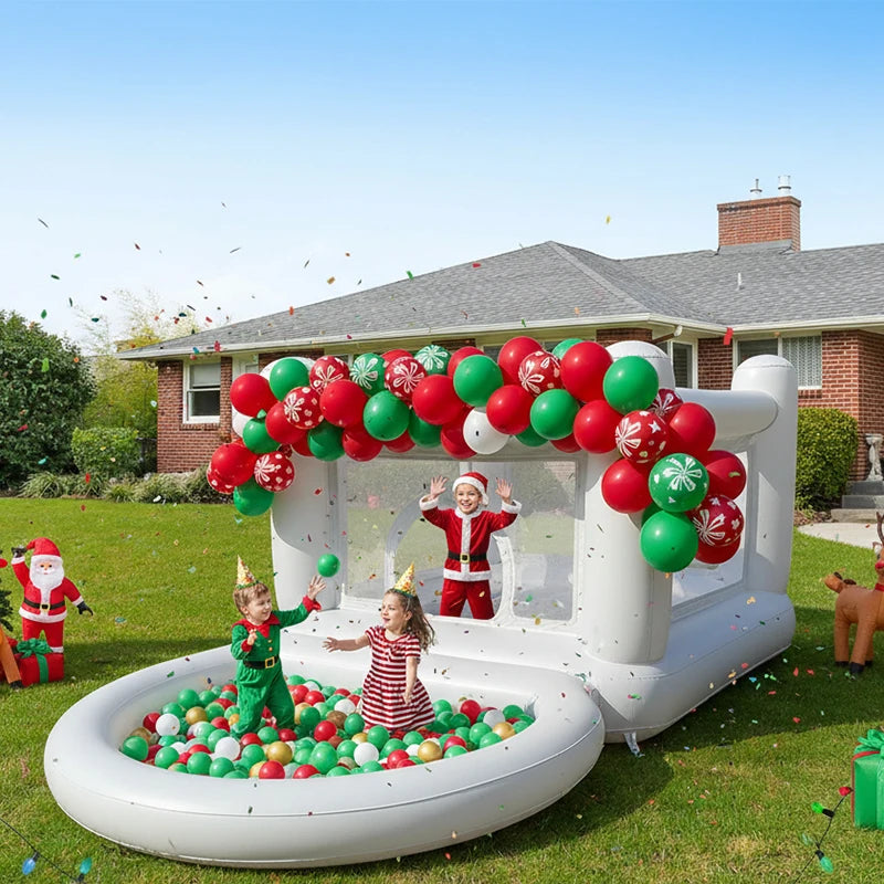 Children playing in a Christmas-themed inflatable play area with balloons and decorations.