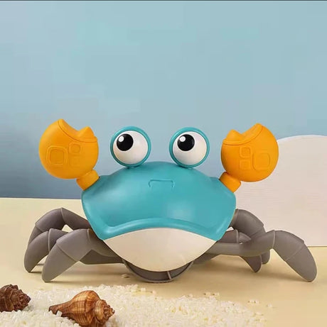 Toy crab on a sandy surface with a blue gradient background
