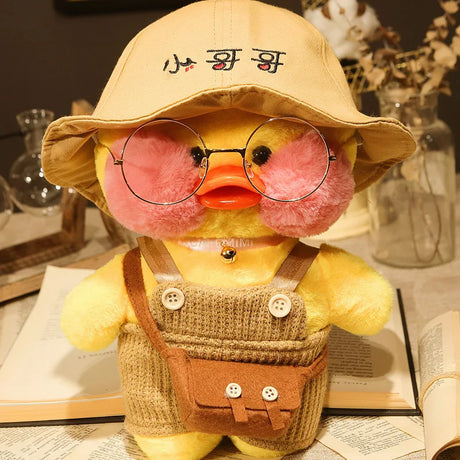 Yellow plush toy with glasses and a hat on a table with books and decorative items.