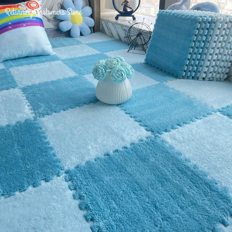Blue checkered foam puzzle mat with a vase of flowers on a checkered floor.