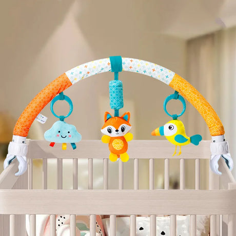 Baby crib arch with colorful toys including a fox, bird, and cloud in a nursery setting.