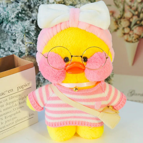 Plush toy duck wearing a pink sweater and glasses with a white bow on a decorative background.