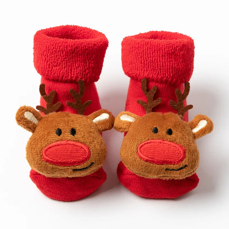 Red baby booties with reindeer faces on a white background